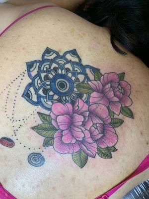 Completed evil eye and peony scar cover up piece